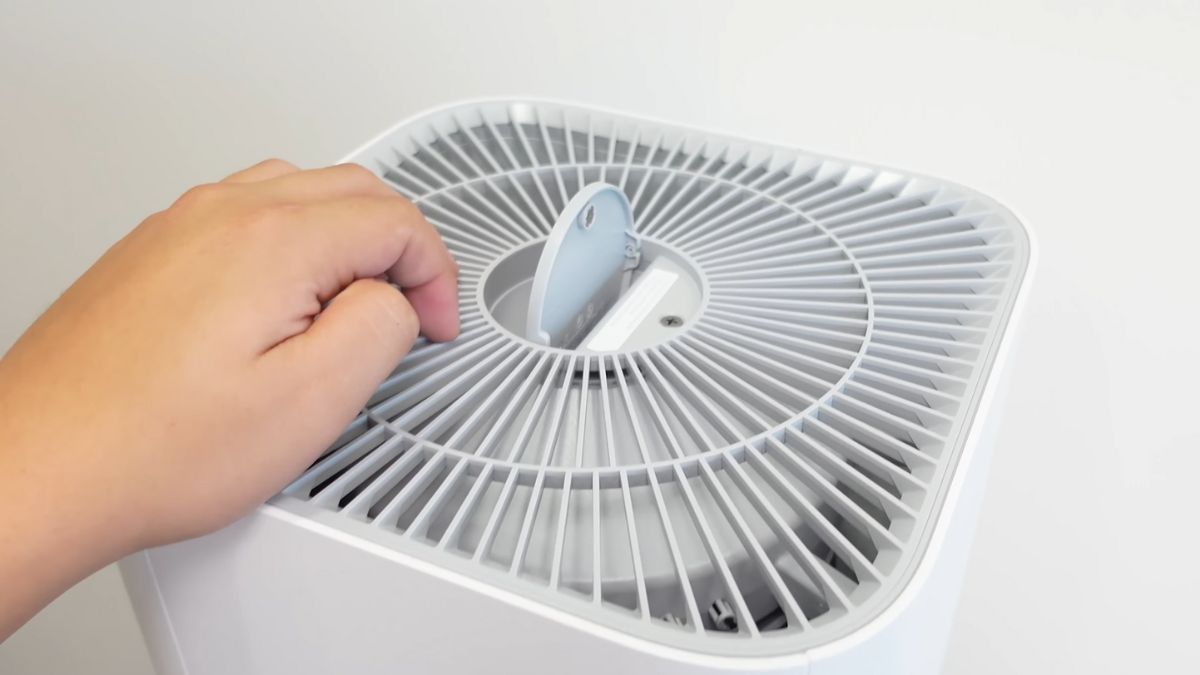 Dùng khăn khô hoặc chổi lông mềm luồn qua khe hở và quét sạch lớp bụi bám trên cánh quạt
